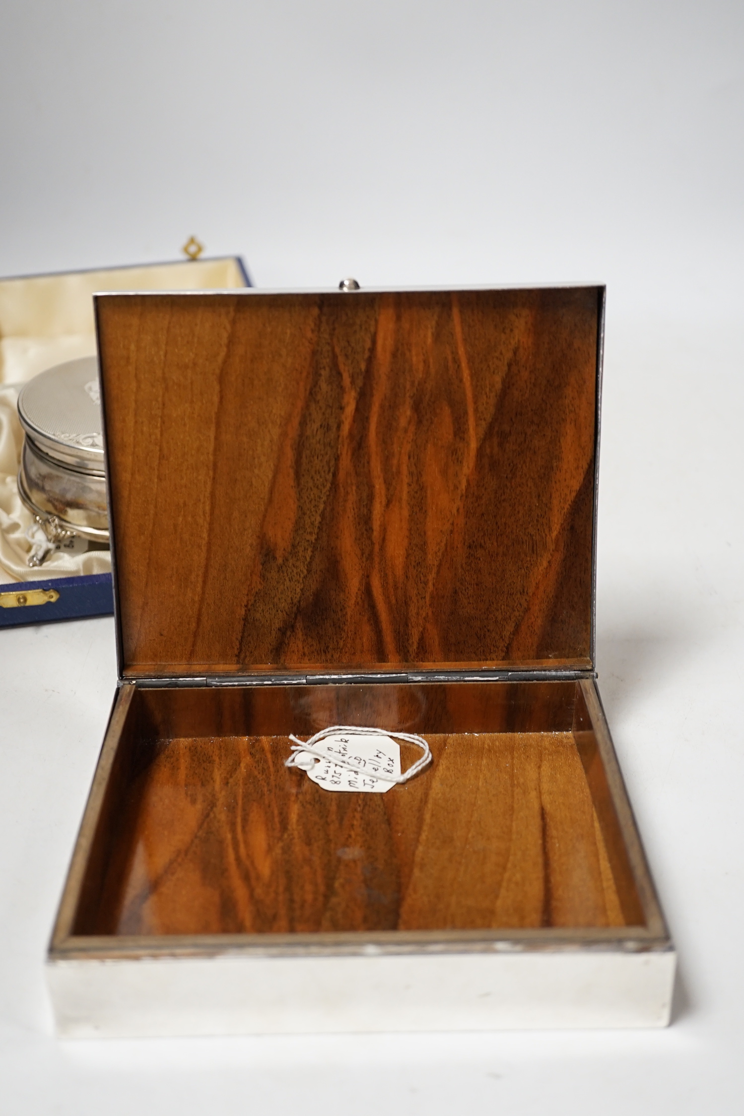 A modern engine turned silver trinket box, Birmingham, 1984, diameter, 82mm, together with a Greek 925 mounted cigarette box by Zolotas, 15cm.